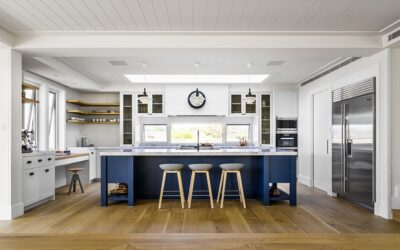 Classic shiplap finishes and Shaker-style cabinetry meet modern functionality in this seaside kitchen